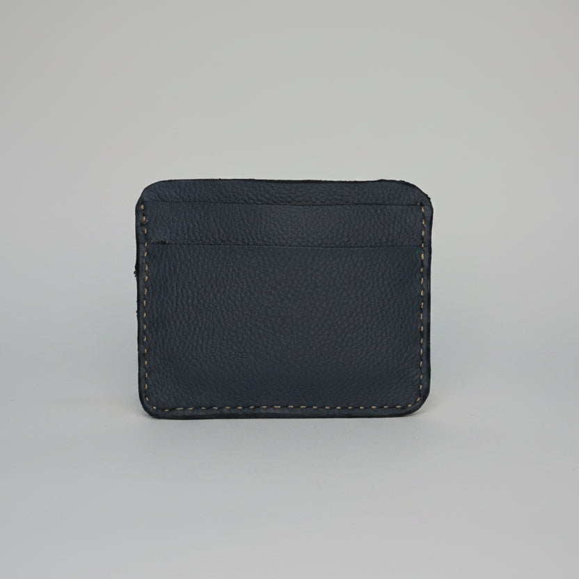 Minimalist blue leather card holder wallet with visible stitching.