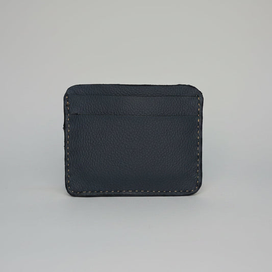 Minimalist blue leather card holder wallet with visible stitching.